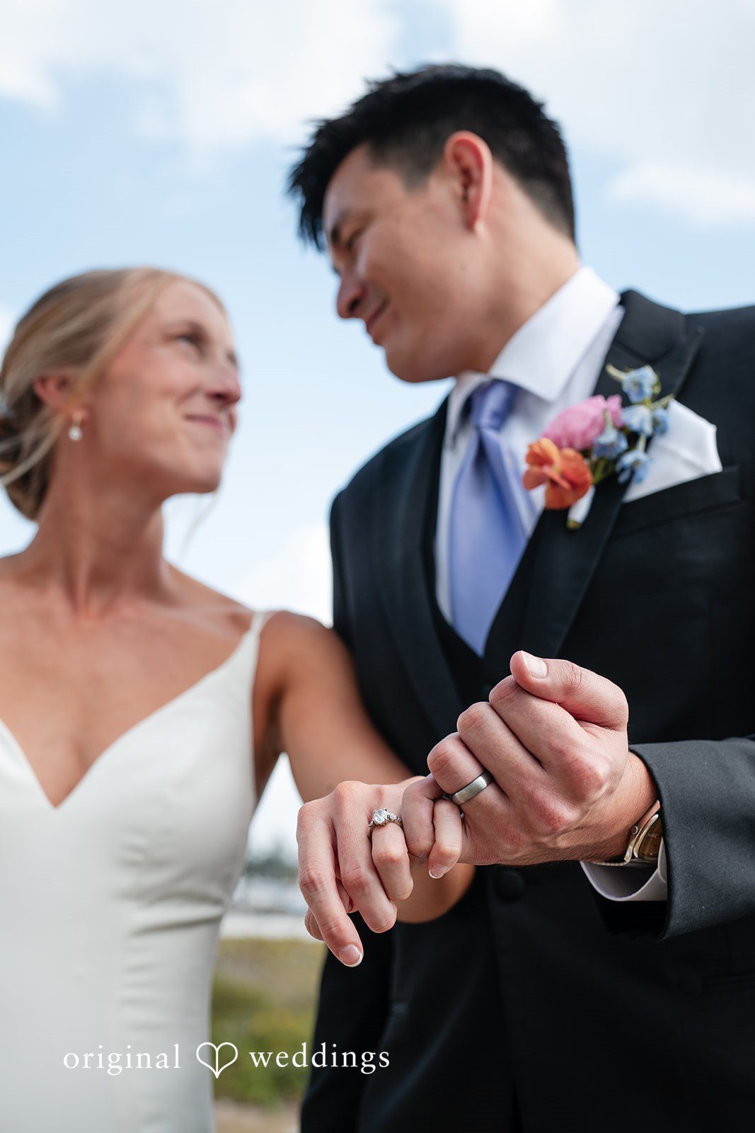 Couple holding fingers while looking at each other at The Resort at Longboat Key Club