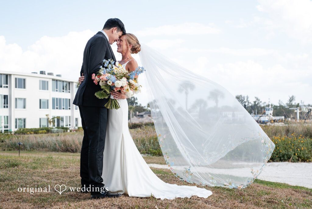 Tampa wedding photographers capturing couple smiling with heads together at The Resort at Longboat Key Club from Original Weddings