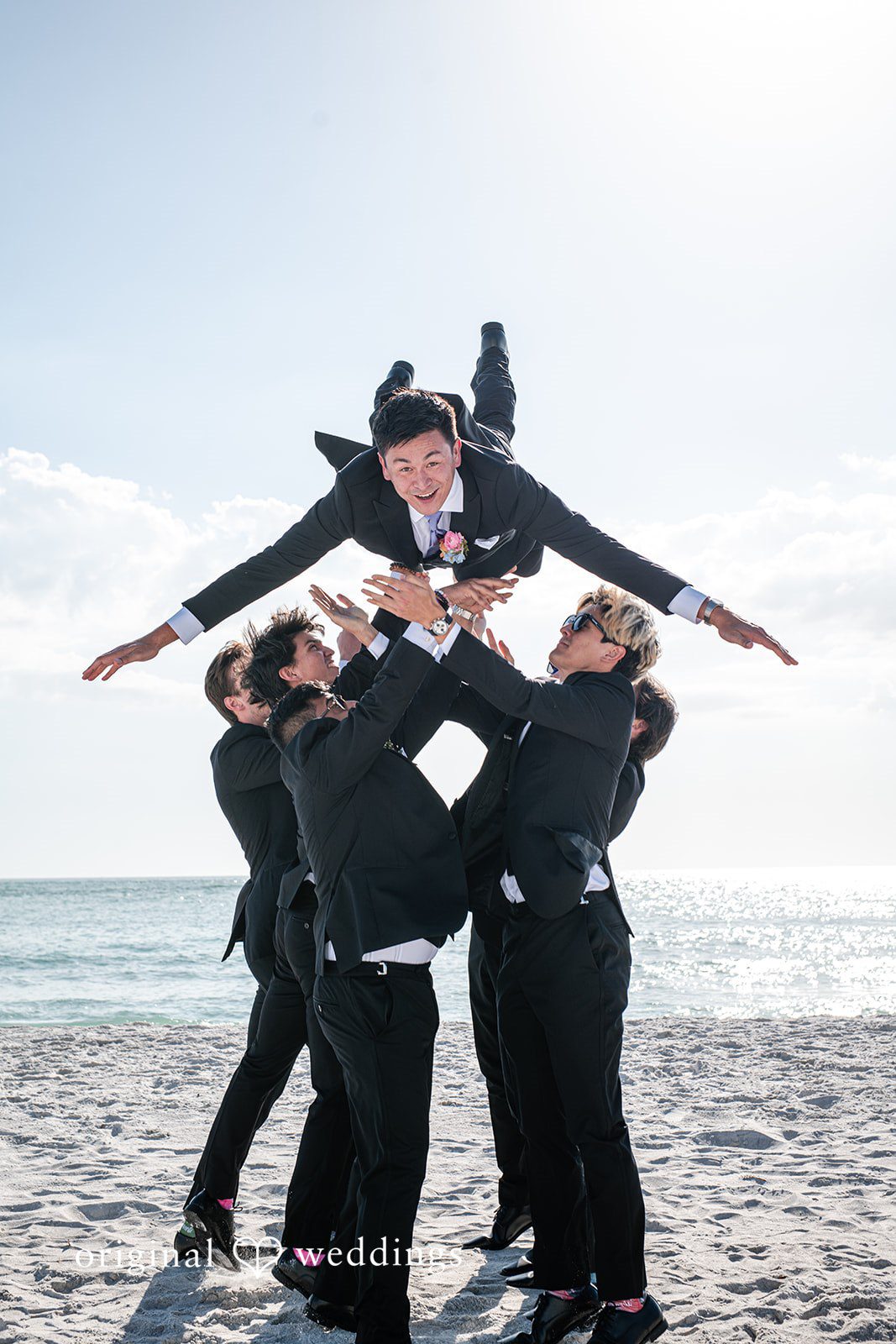 Groom posing with groomsmen in the beautiful way
