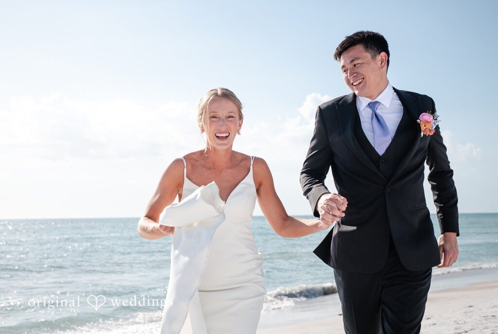 Tampa wedding photographers capturing romantic moment of couple holding hands and smiling at The Resort at Longboat Key Club from Original Weddings
