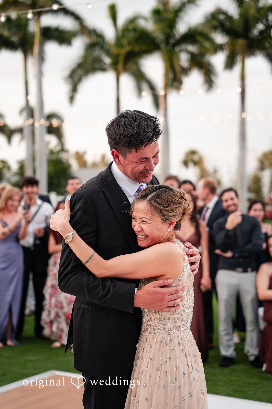 Groom hugging the  lady during the celebration at The Resort at Longboat Key Club