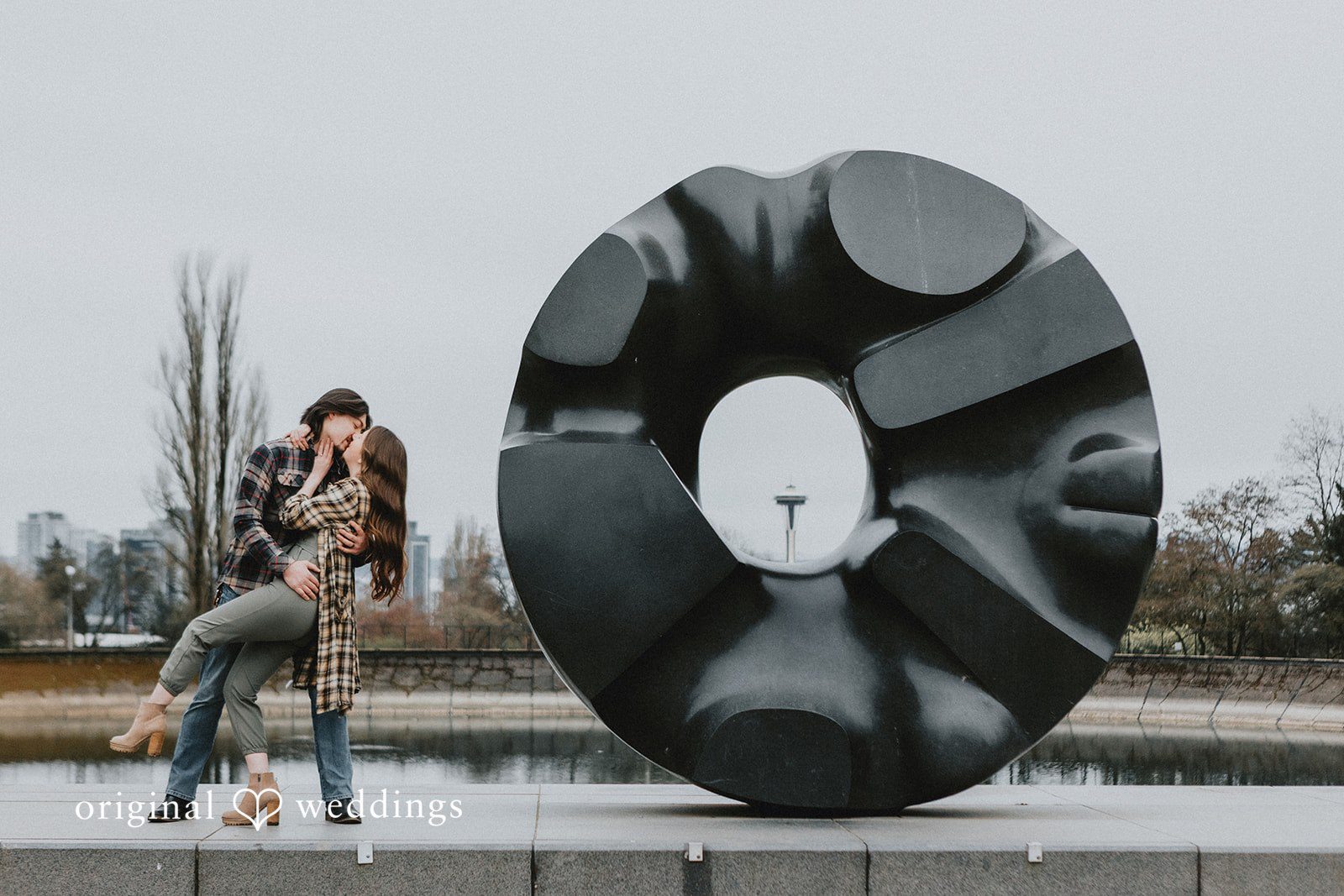 Lovely couple kissing while posing at Volunteer Park
