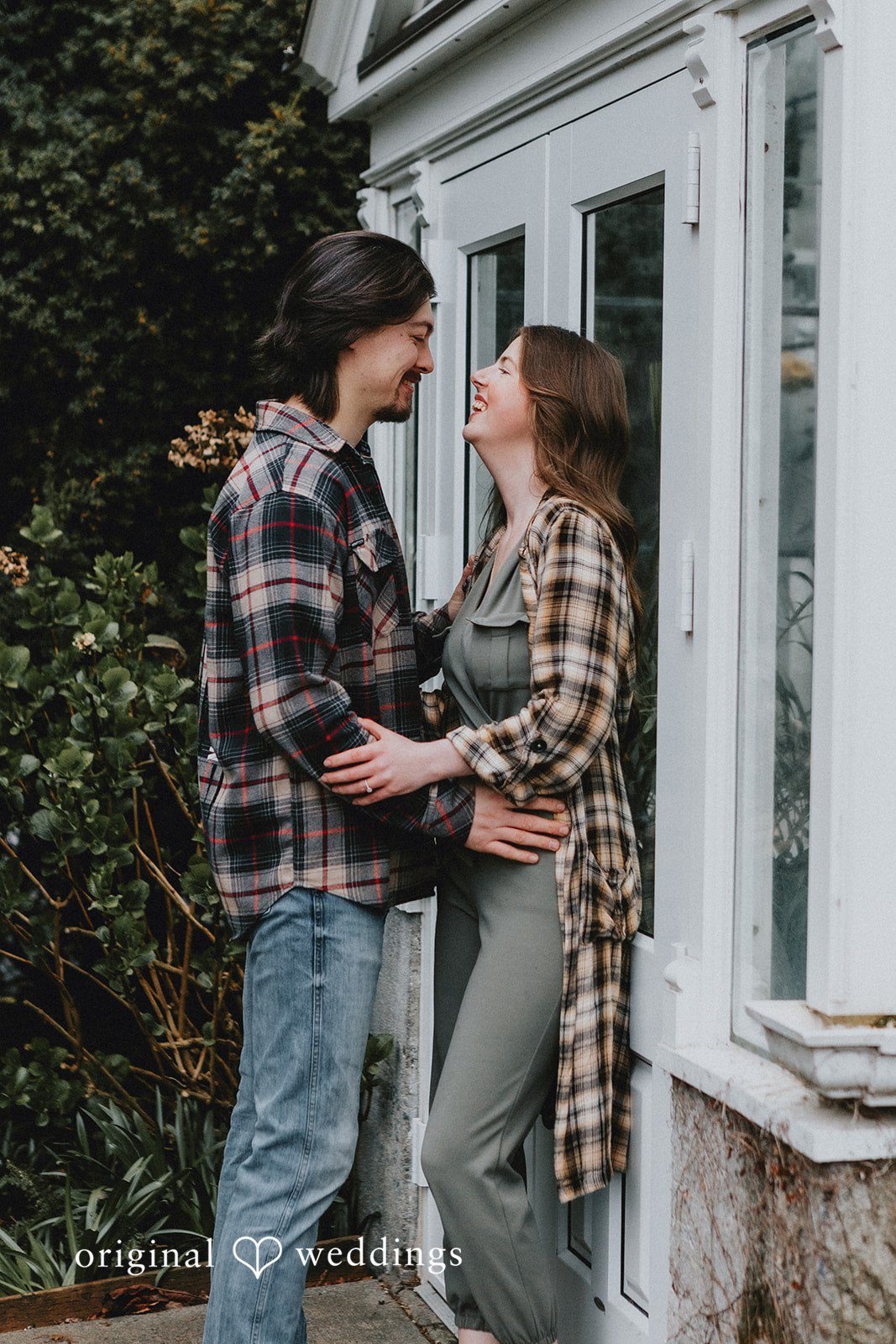 Couple looking into each other’s eyes and smiling naturally at Volunteer Park