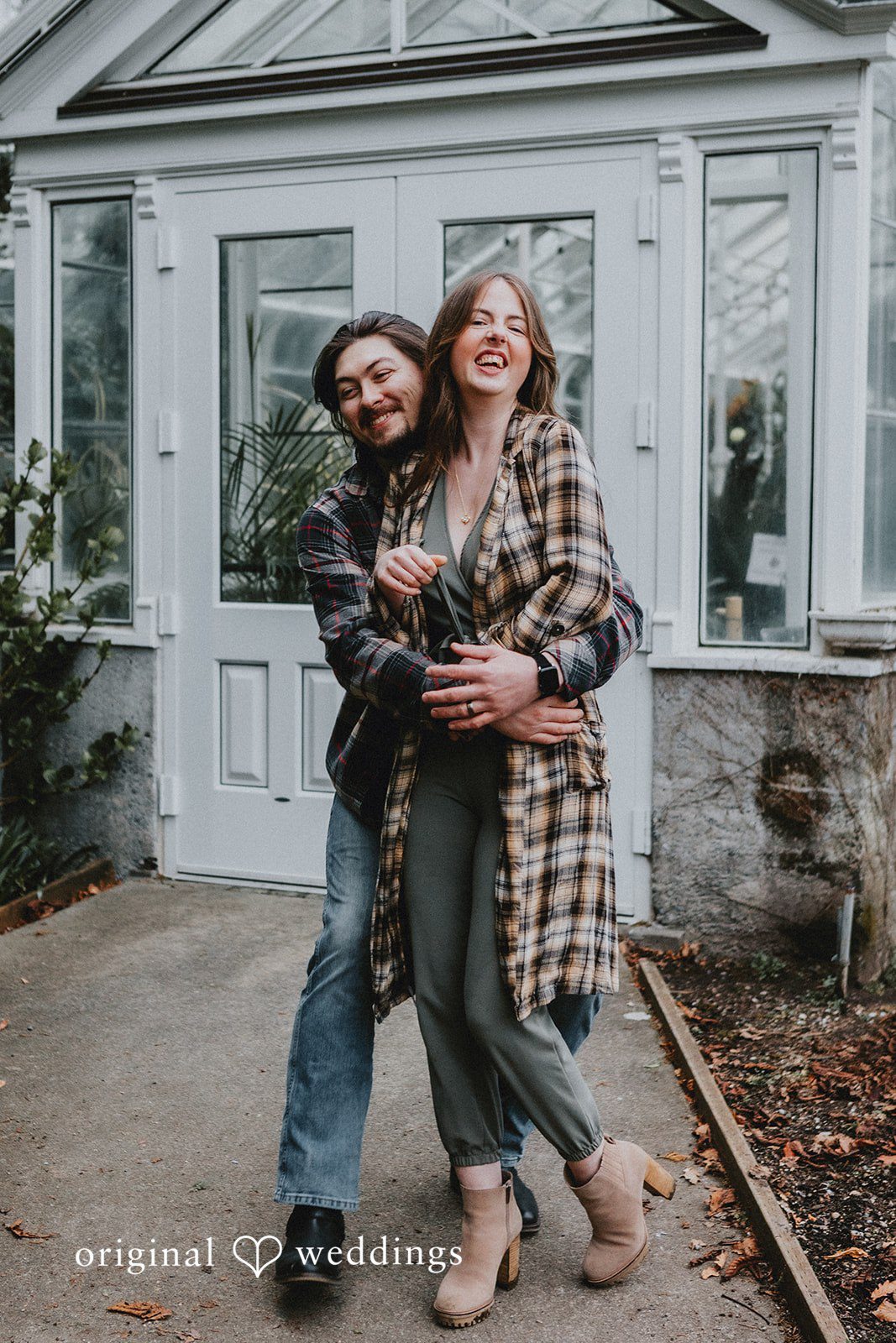 Joyful couple enjoying a back hug during photo session