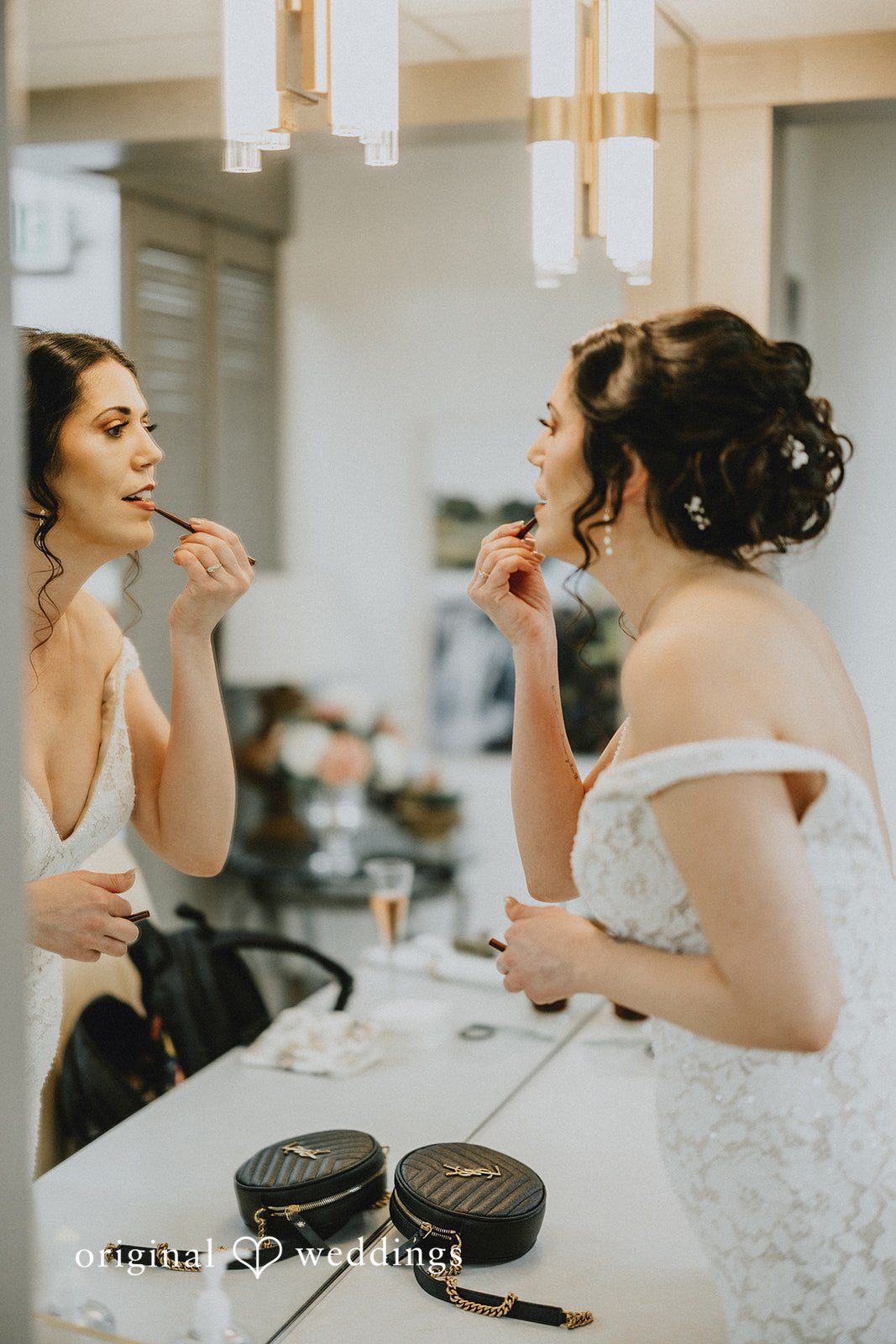 Parsa + Kiley The bride applies final touches while looking into the mirror.