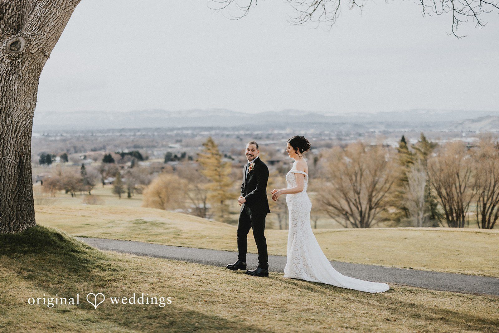 Parsa + Kiley The couple walks together with a breathtaking landscape behind them.