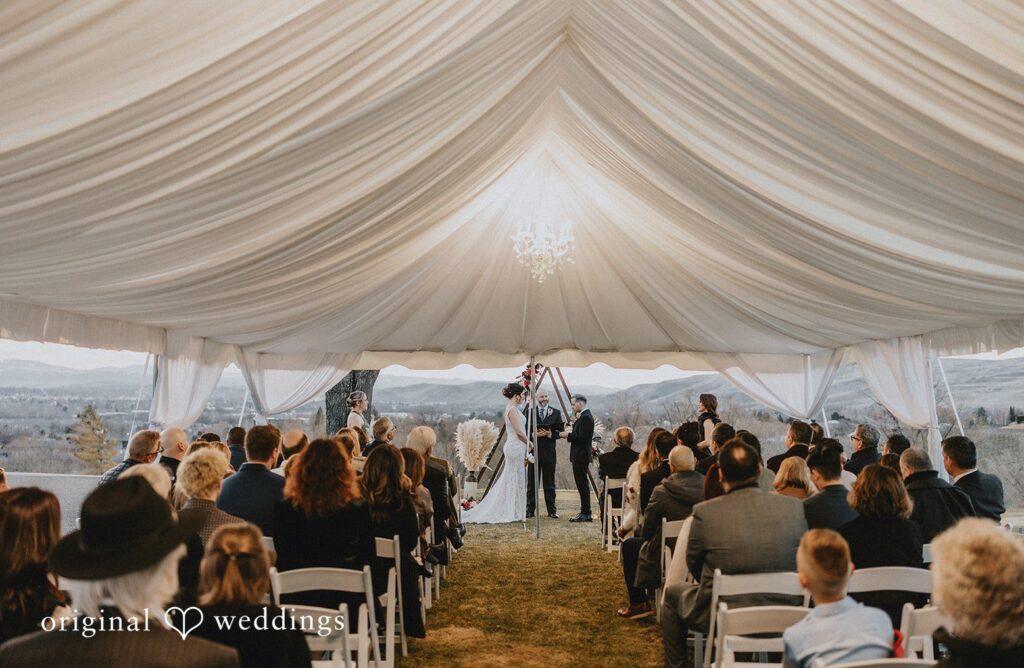 The ceremony under the tent feels lively and full of guests, beautifully captured through Seattle wedding photography.