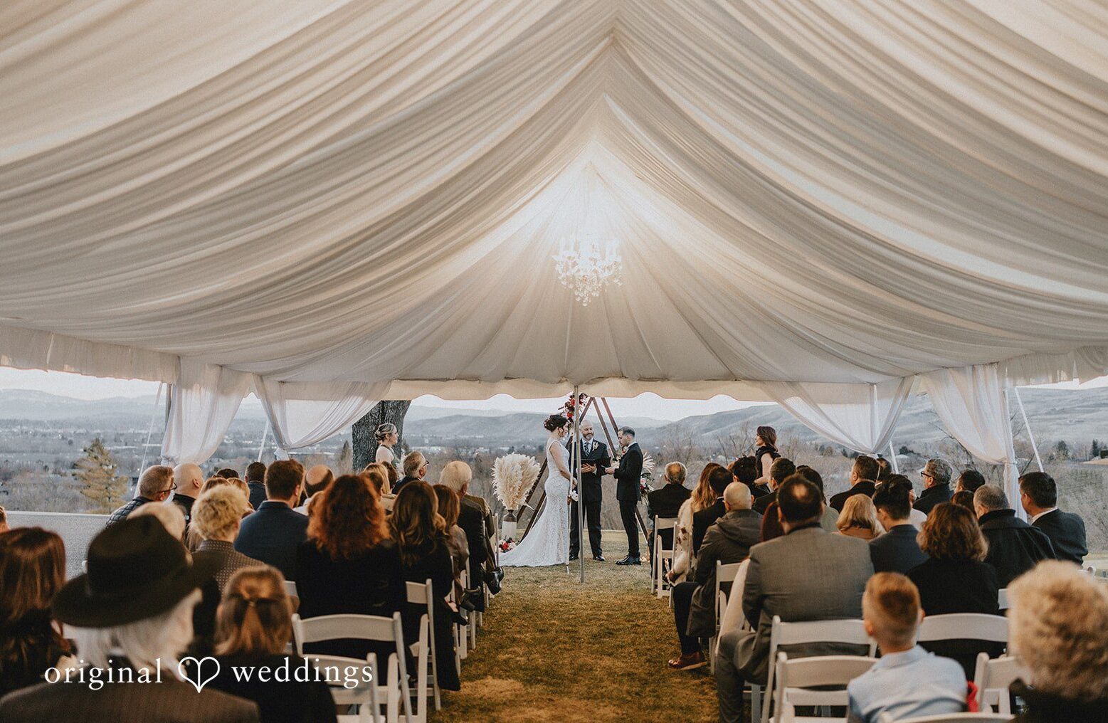 The ceremony under the tent feels lively and full of guests, beautifully captured through Seattle wedding photography.