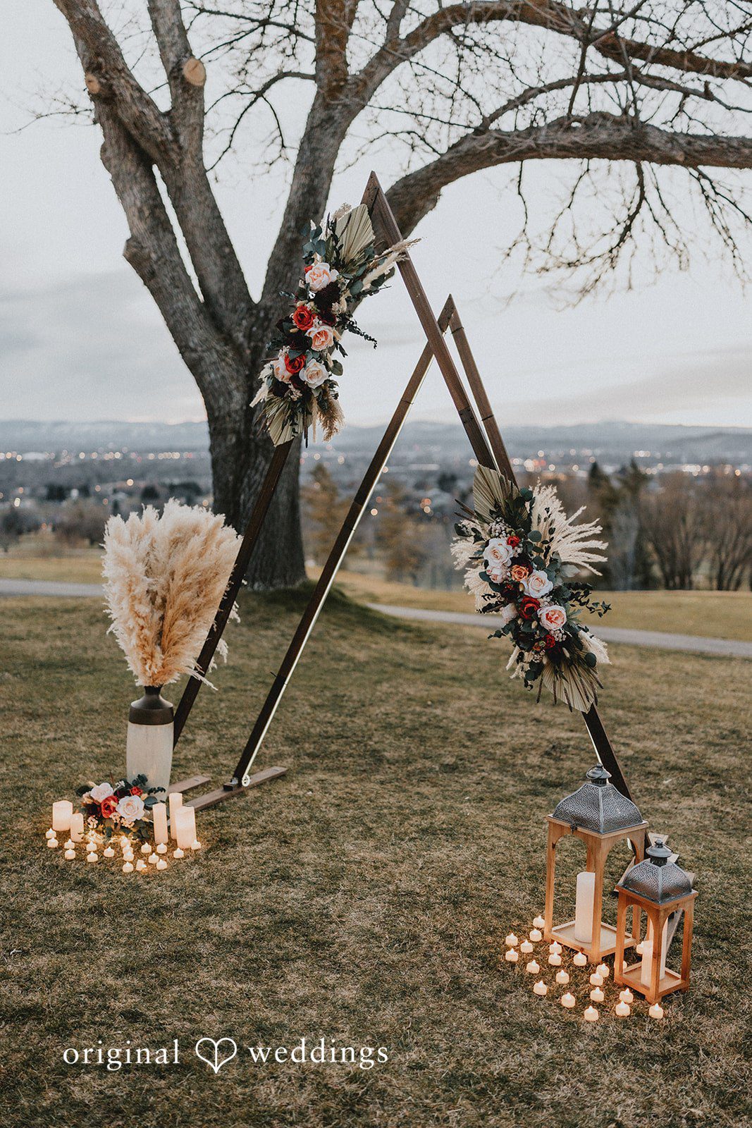 Parsa + Kiley A floral wedding arch stands beautifully against a scenic landscape.