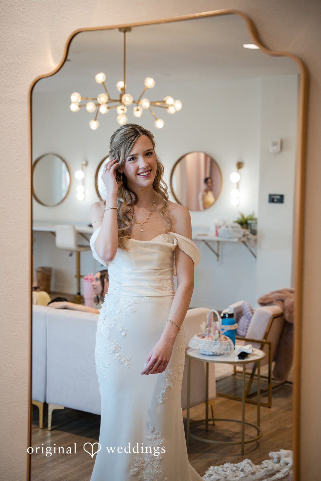 Bride posing near a mirror after wedding preparations