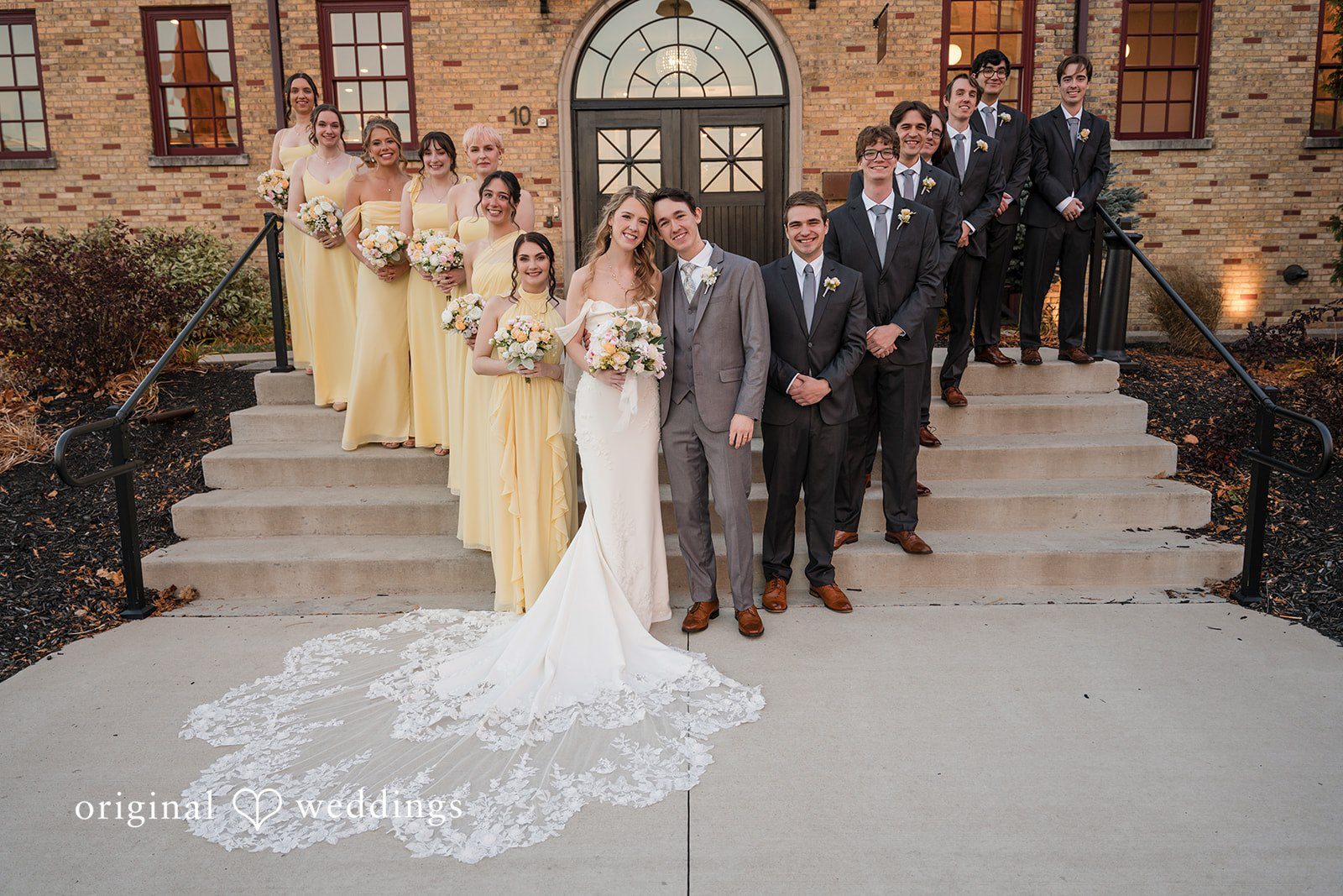 Bride and groom posing with the full wedding party