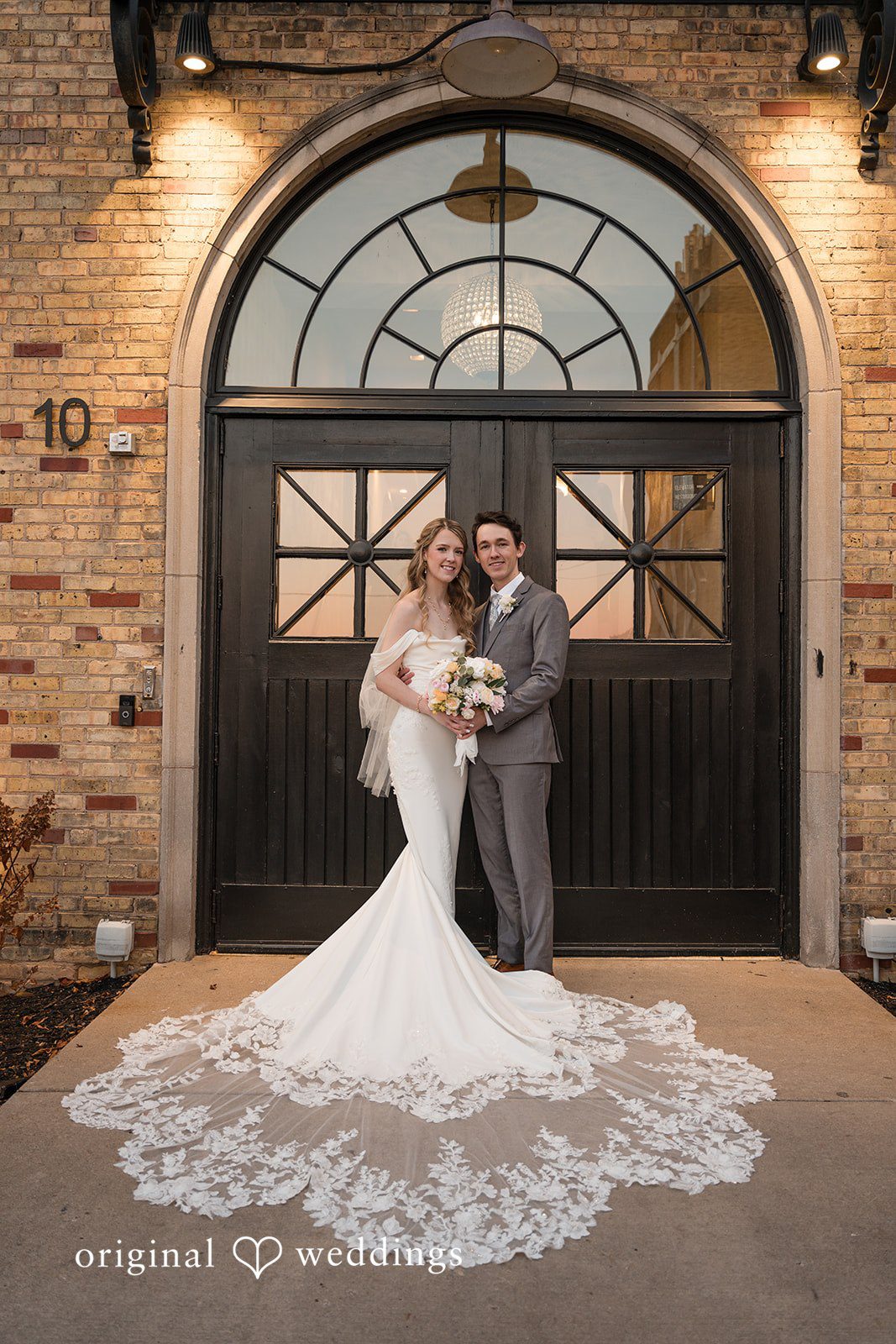 Couple portrait outside the wedding venue entrance
