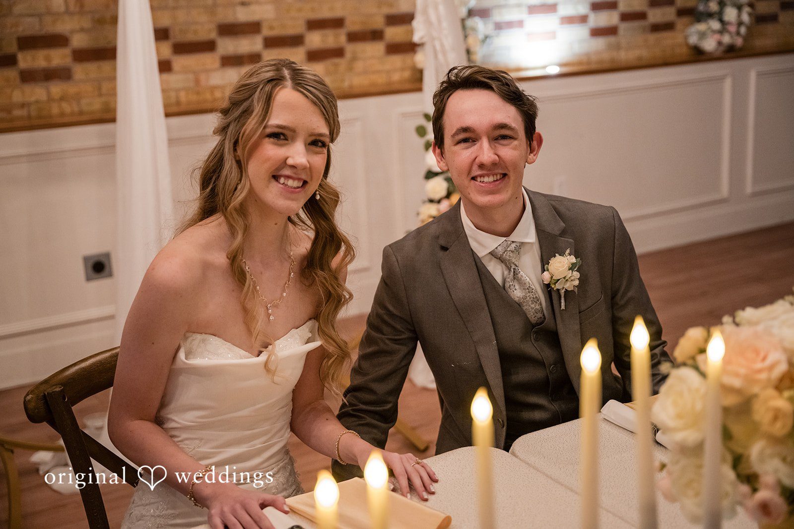 Bride and groom seated together at the reception tables
