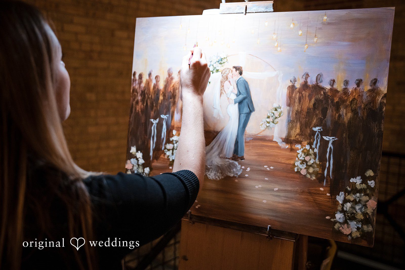 Wedding painter creating a portrait of the couple during the reception