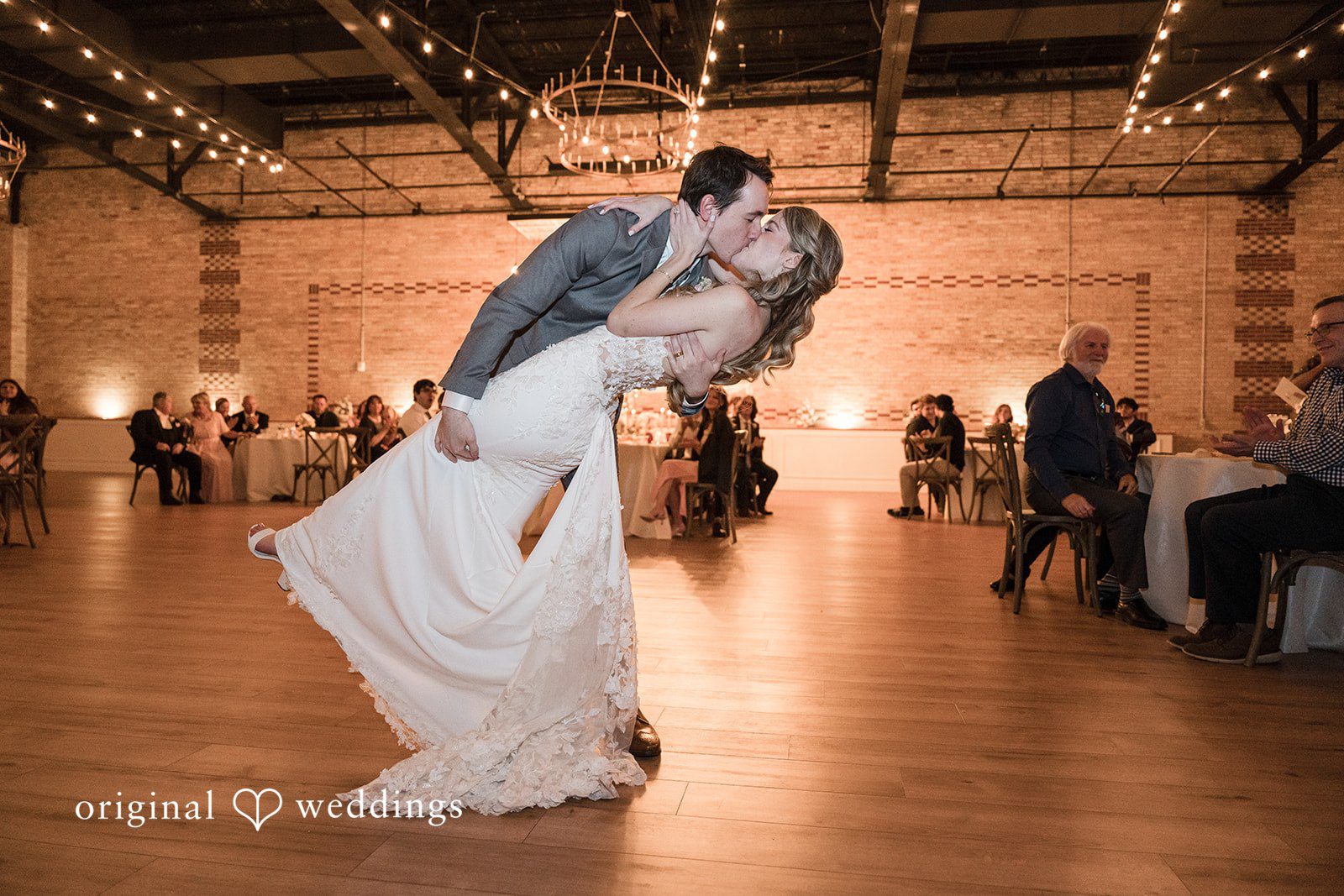 Groom kissing the bride at the end of the reception celebration