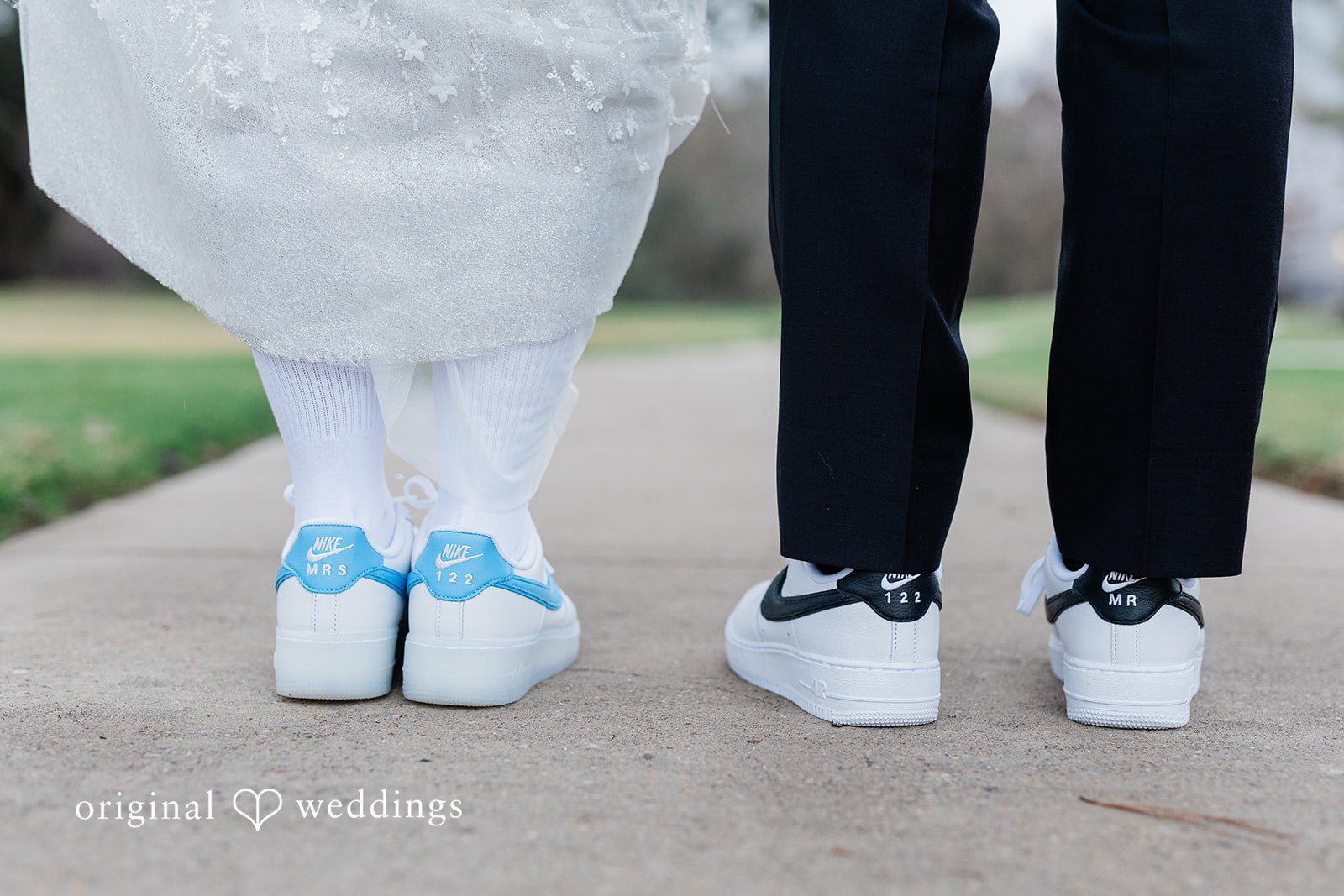 Dominic + Erika Joy Close-up of a couple's personalized white sneakers with blue and black accents.