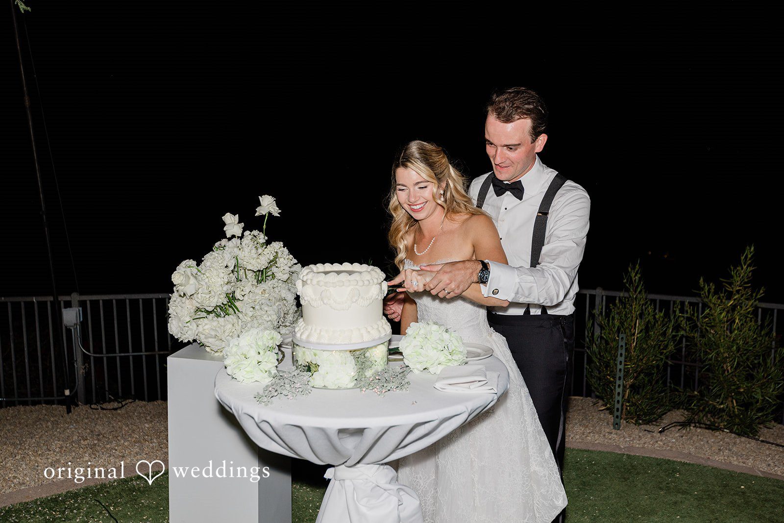 Kathryn + Calum Couple cutting their wedding cake during the reception celebration