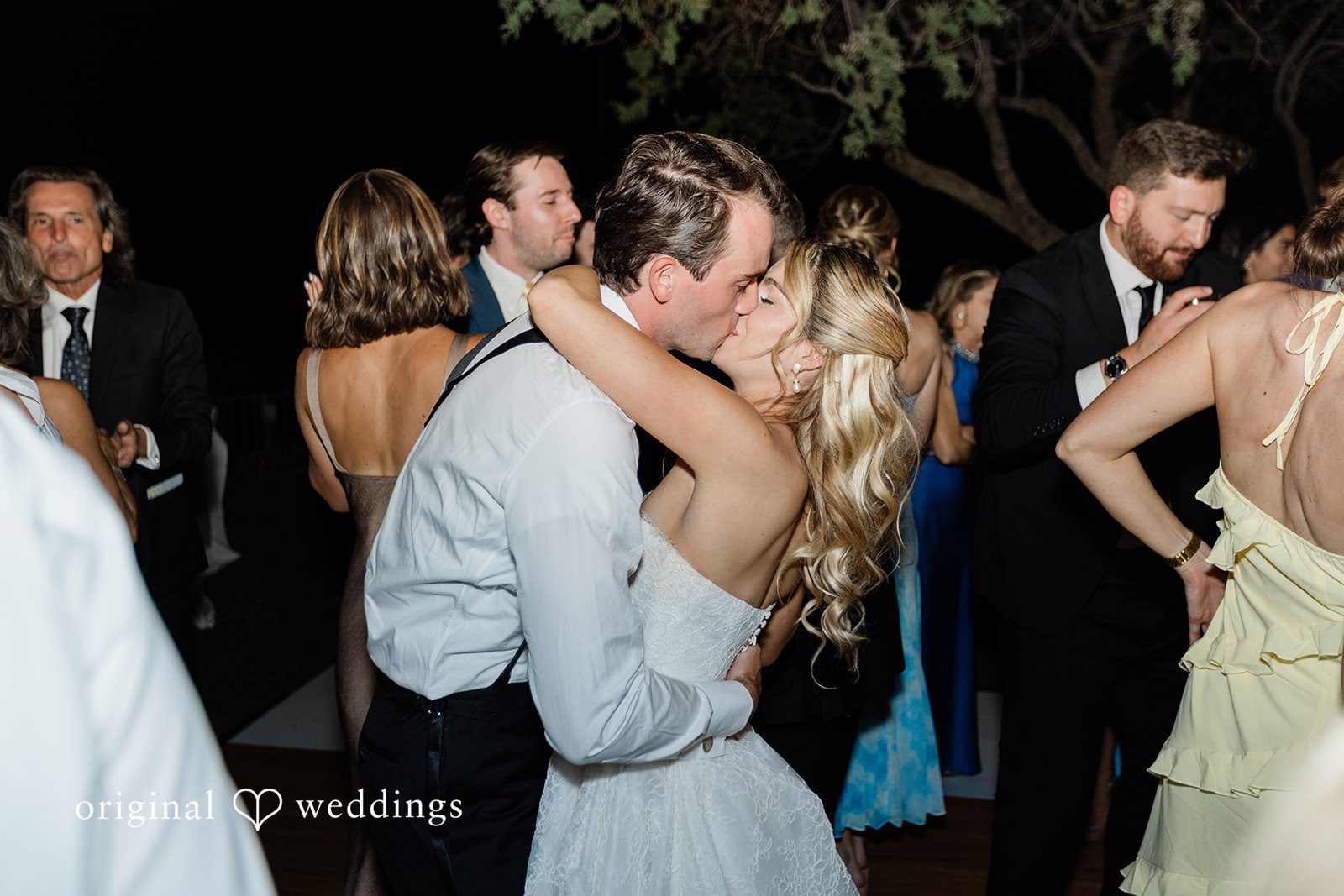 Kathryn + Calum Couple celebrating and kissing together on the dance floor at the reception