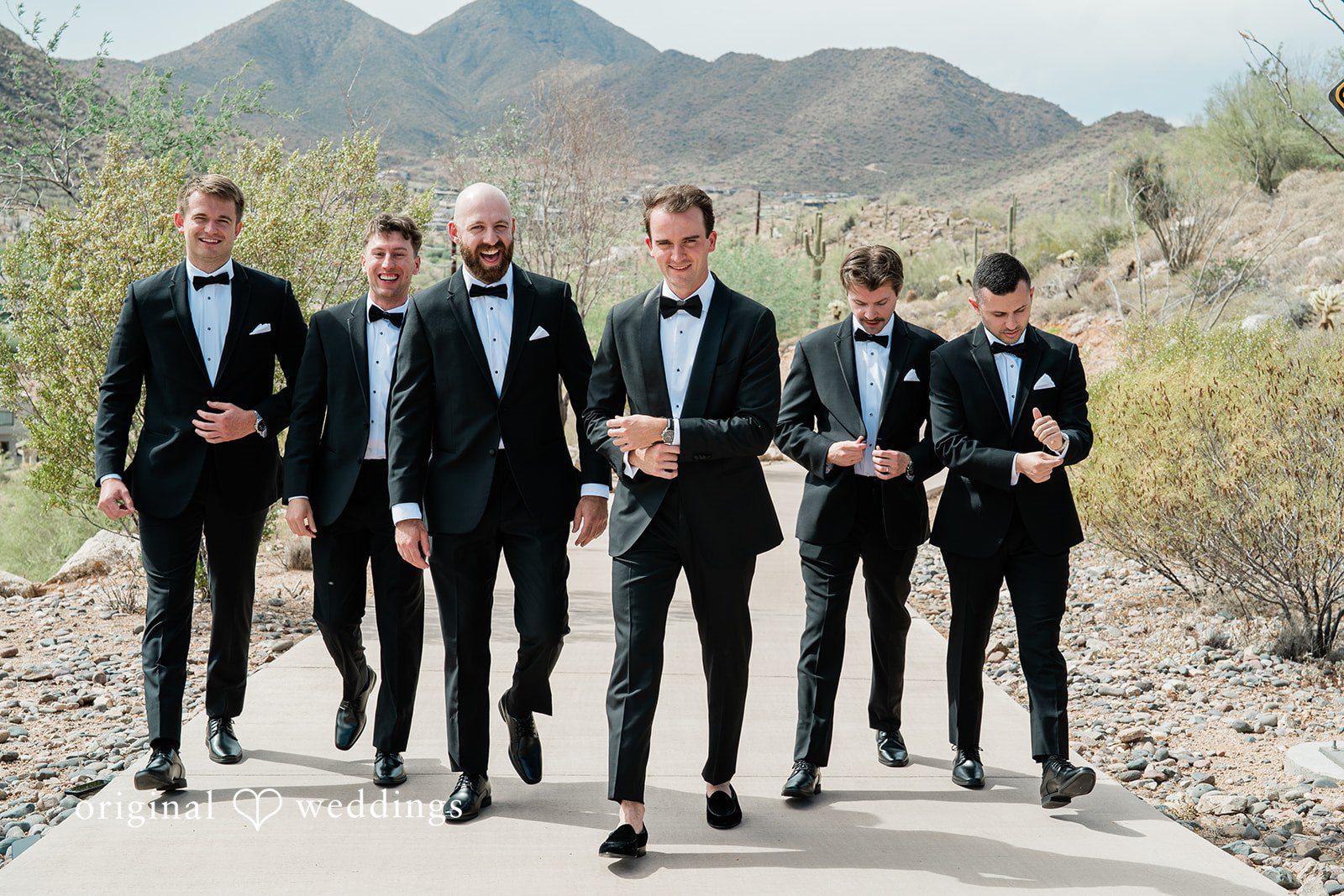Kathryn + Calum Groom posing with groomsmen outside the venue