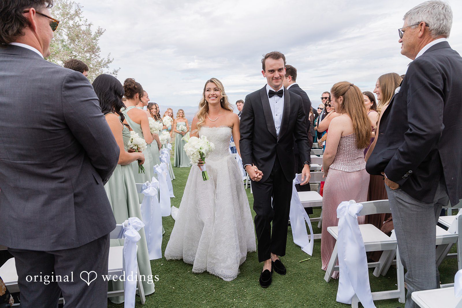 Kathryn + Calum Newlyweds walking hand in hand after the ceremony