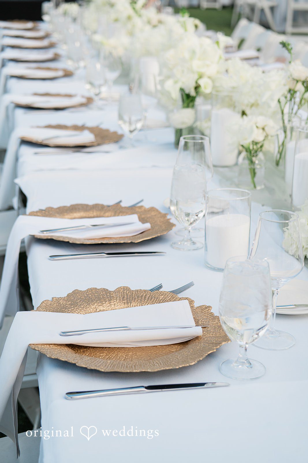 Kathryn + Calum Close-up of wedding table decor with candles and floral details