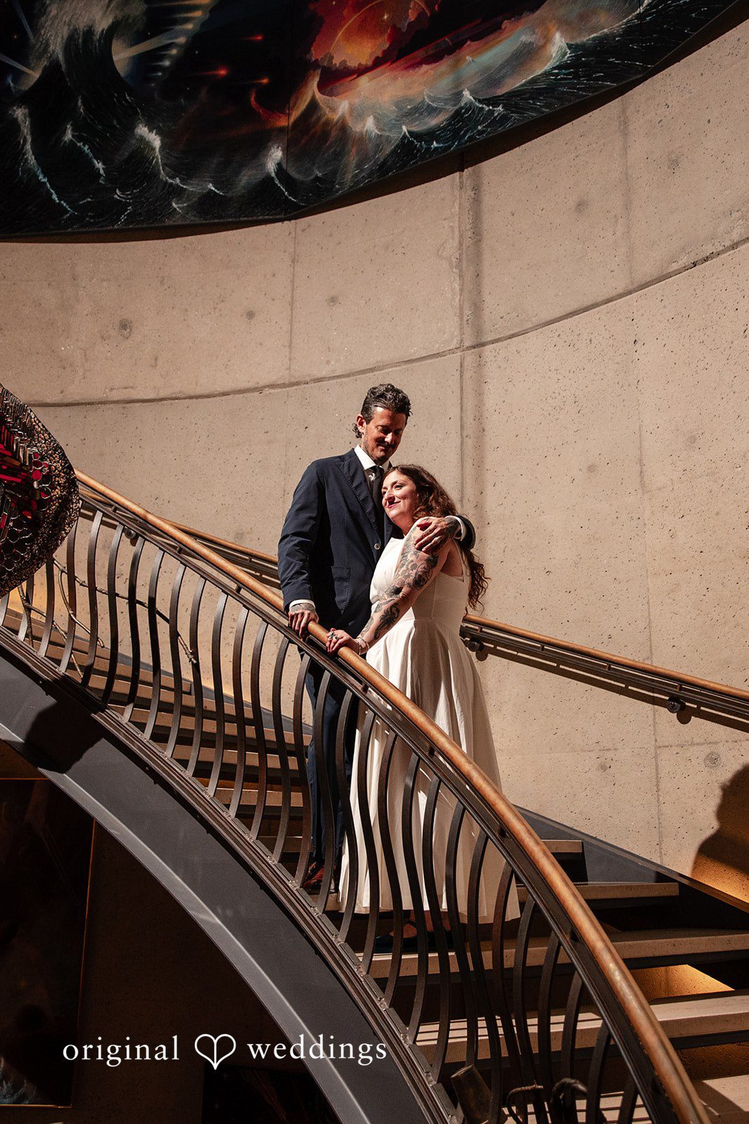 Leah + Daniel Bride and groom posing together on the venue staircase