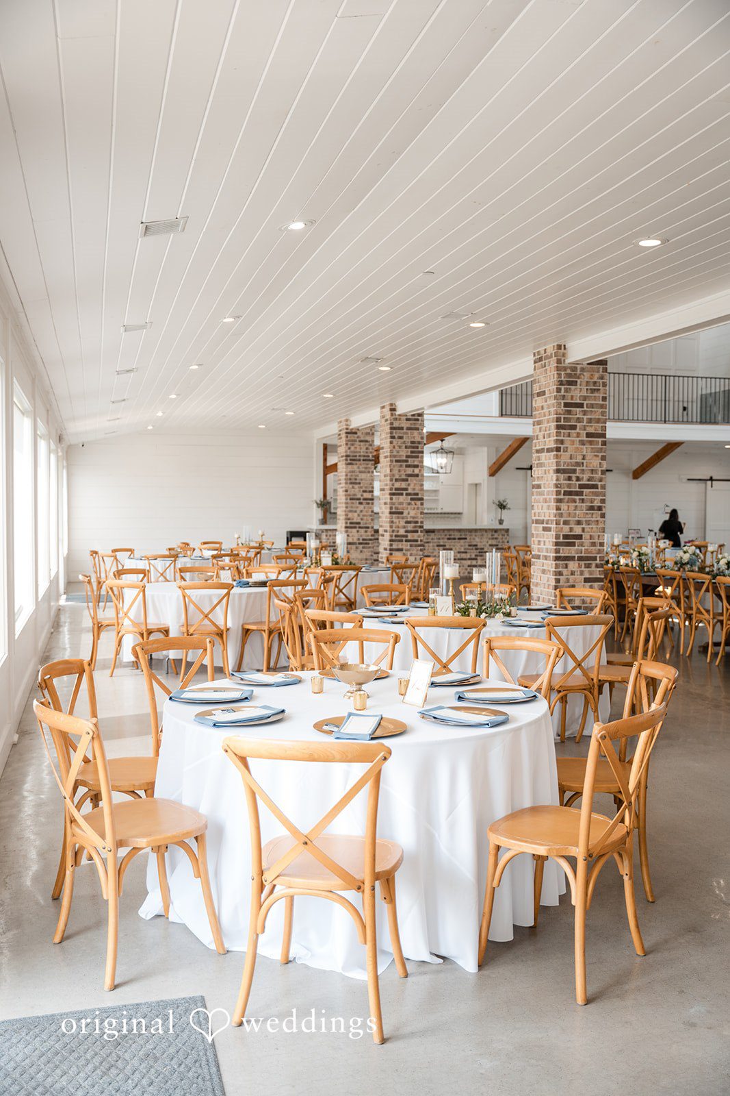 Kennedy + Collin Neatly arranged tables at the wedding reception hall