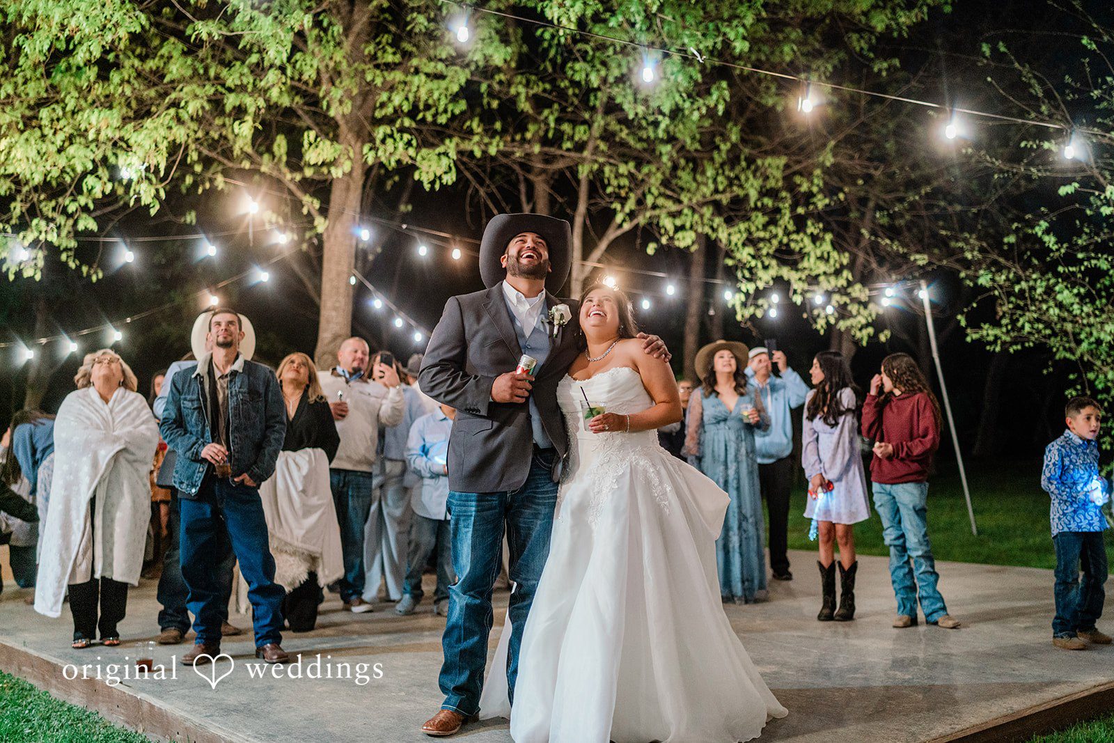 The couple and their wedding guests having fun at night