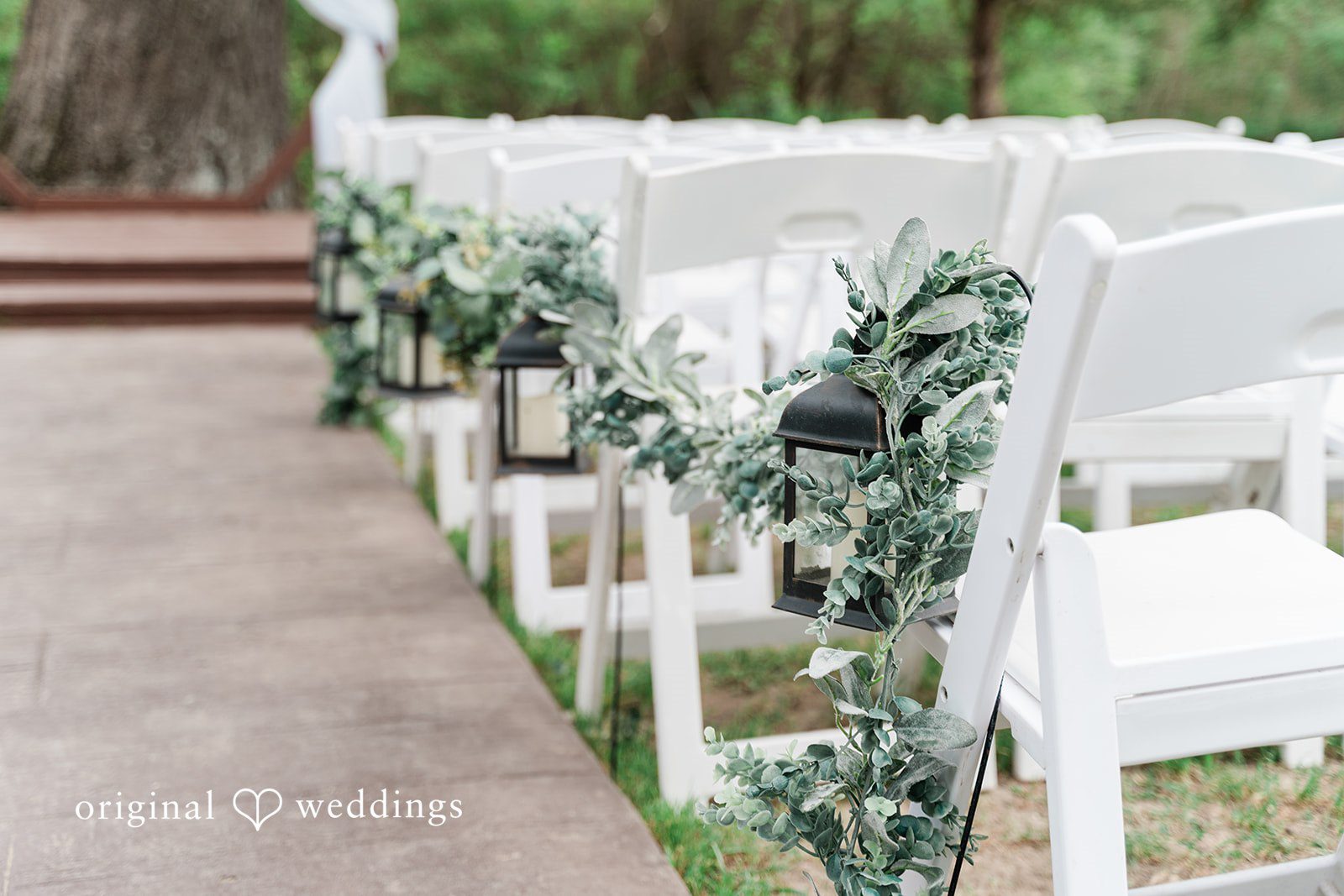 White chairs decorated with green florals