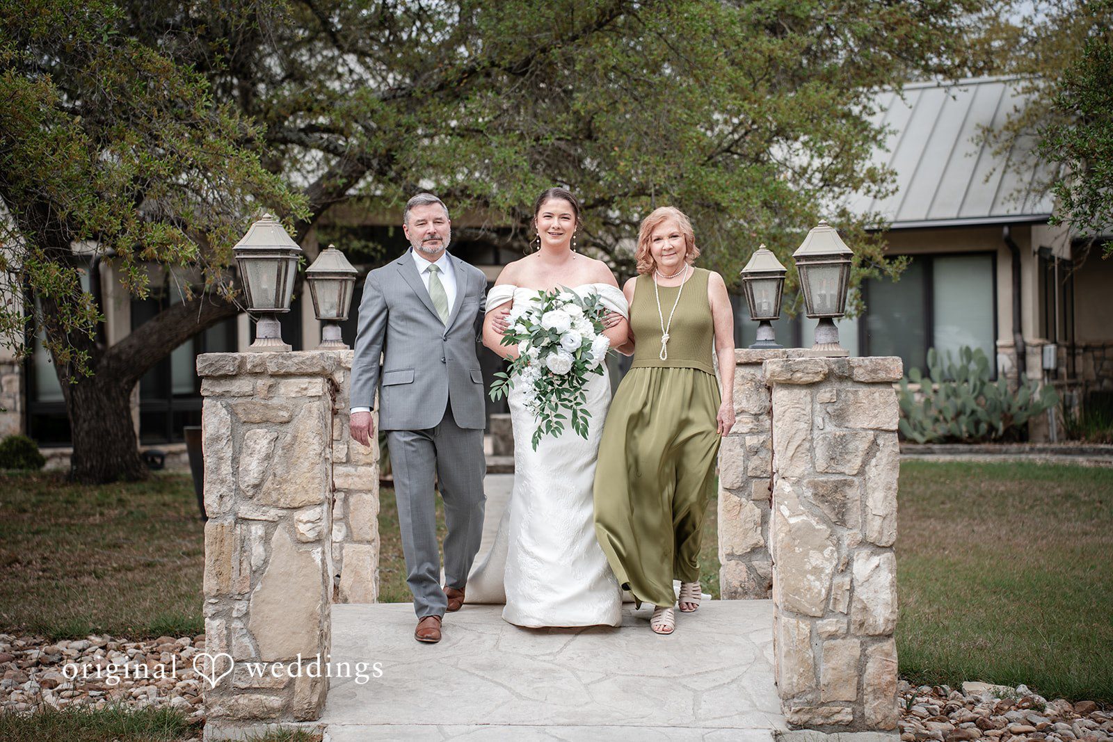 Hannah + Will Bride walking down the aisle with her family