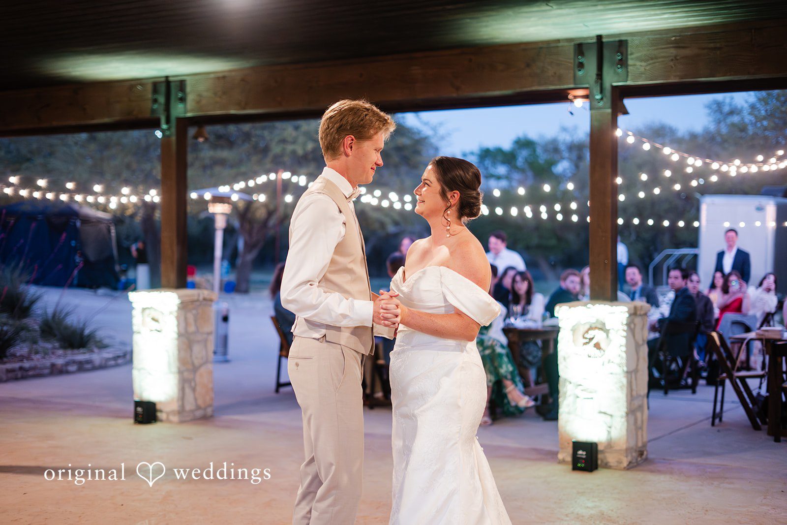 Hannah + Will First dance under string lights outdoors