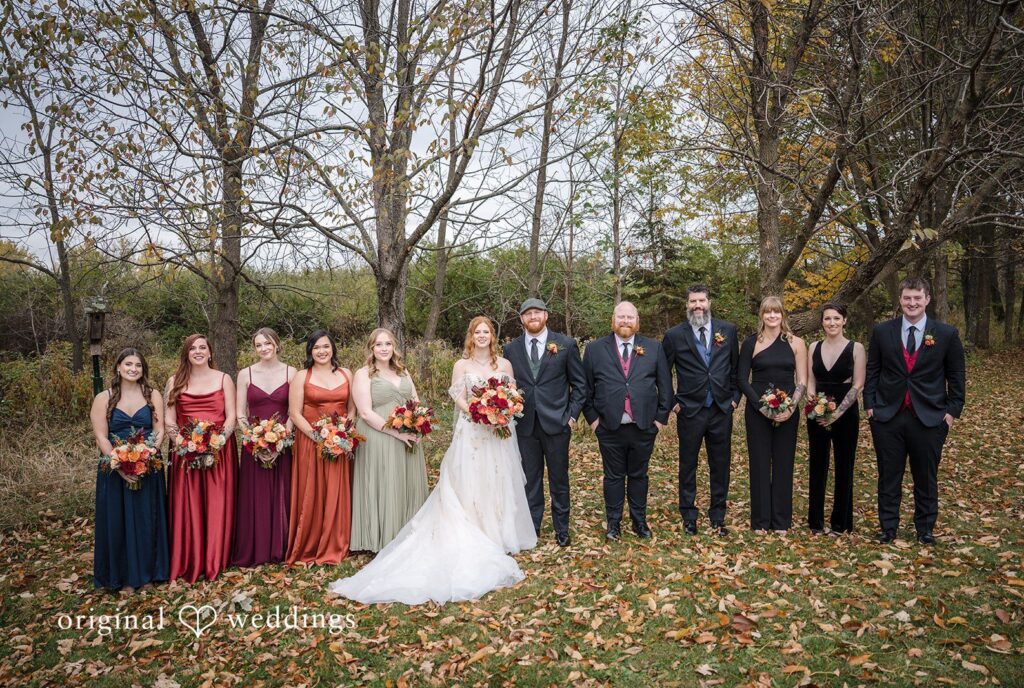 William + Alicia Madison Wedding Photographers capturing couple group photo with bridesmaids and groomsmen at Barnwood Events by Original Weddings