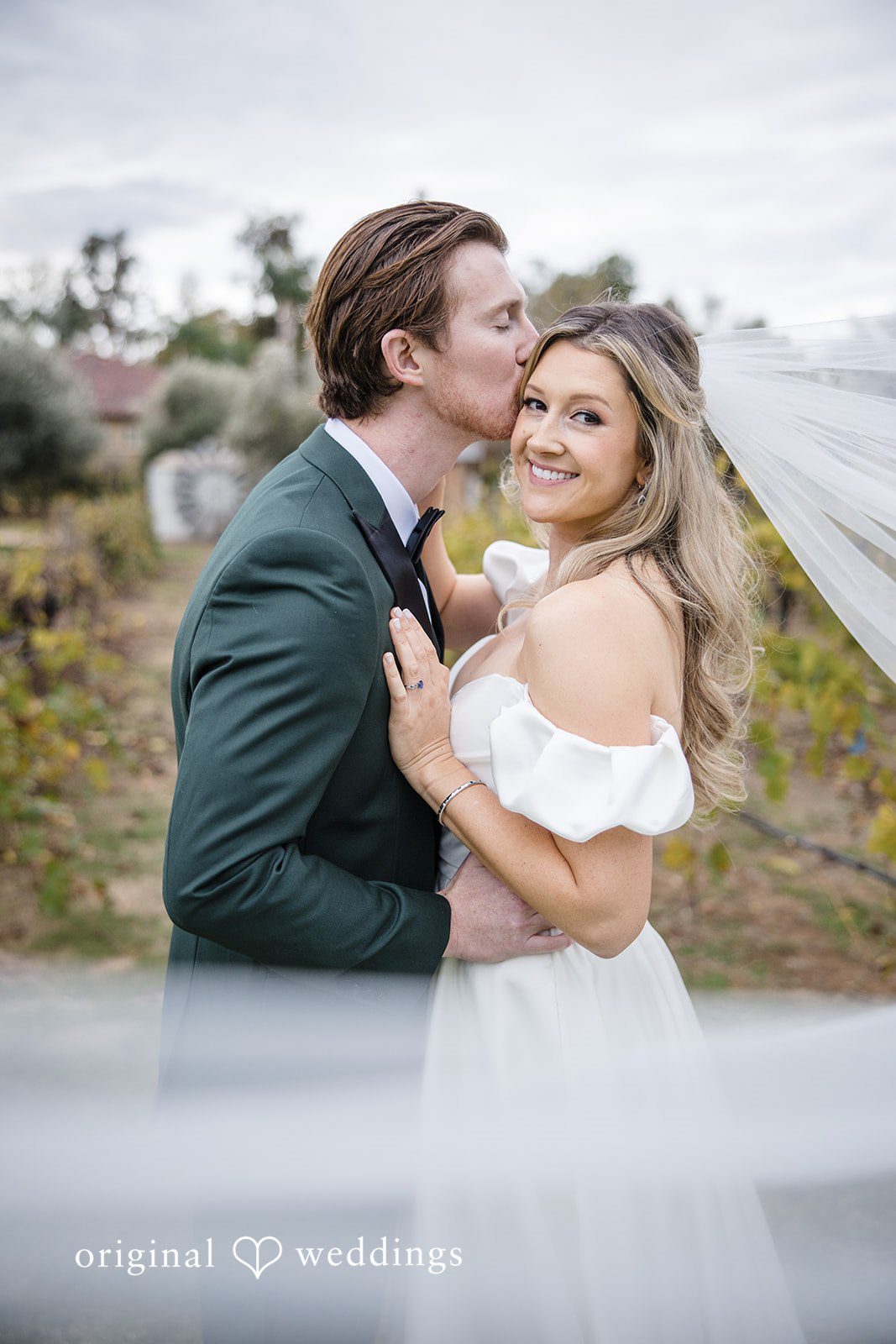 Olivia + Connor Groom kissing the bride on the forehead during portraits