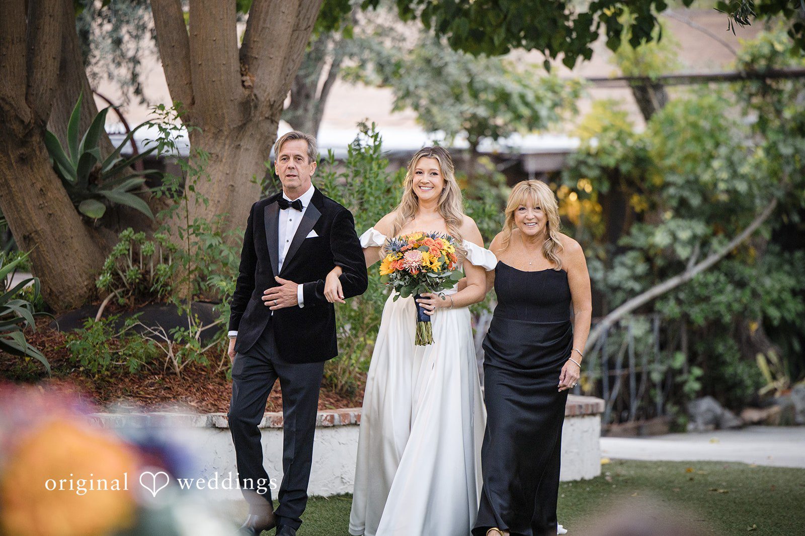 Olivia + Connor Bride walking to the ceremony with her mother and father