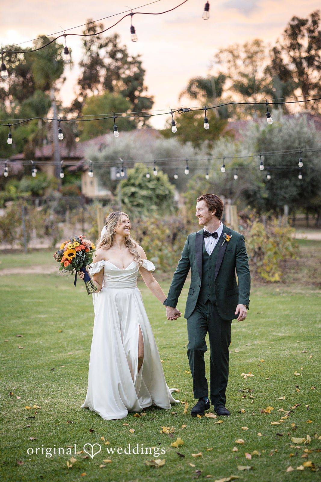 Olivia + Connor Bride and groom walking hand in hand during sunset portraits