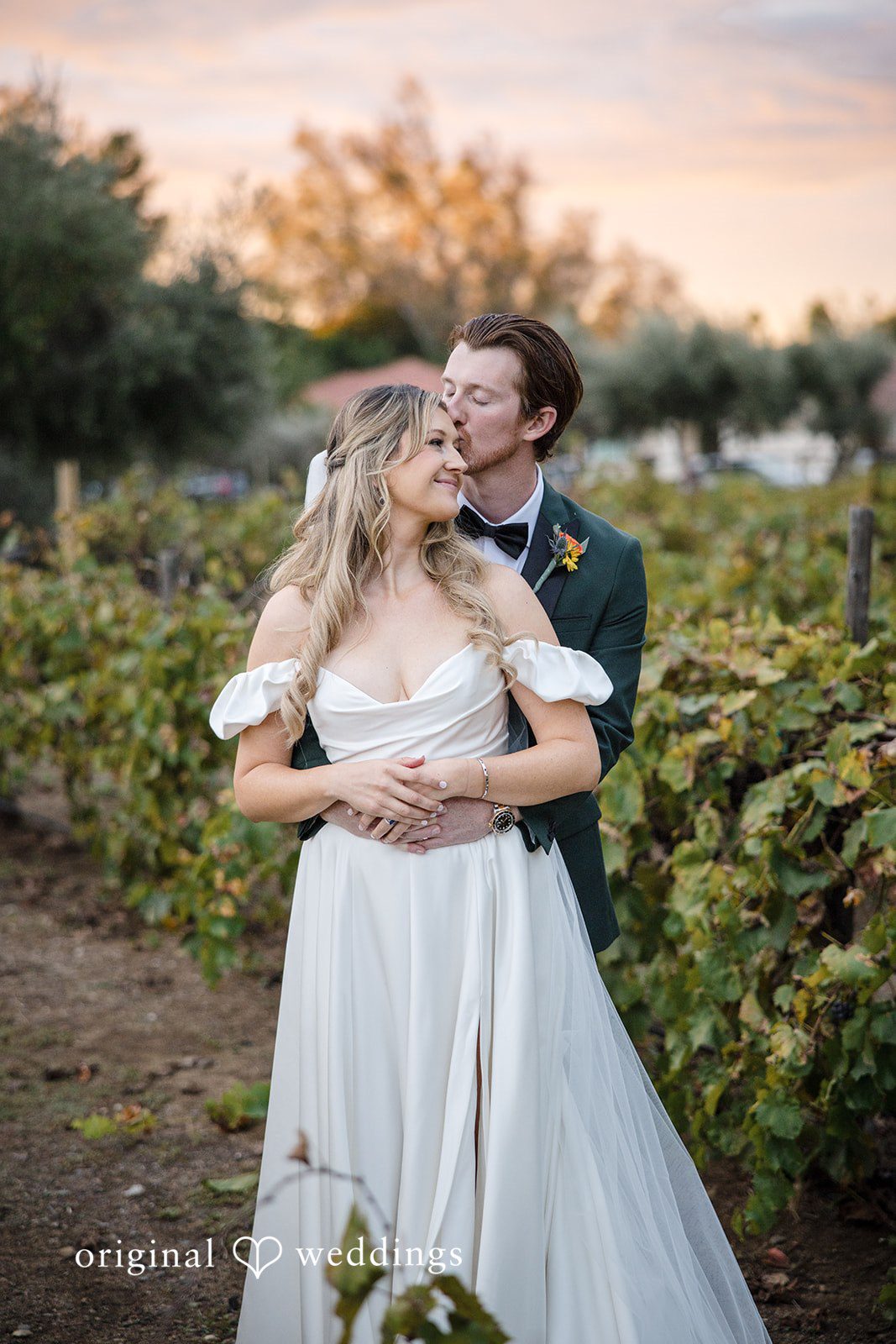 Olivia + Connor Groom hugging the bride from behind during outdoor portraits