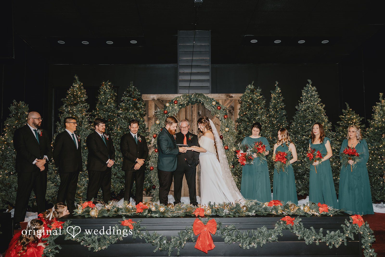 Bride and groom exchanging vows during Christmas themed wedding ceremony at Bethel Baptist Church
