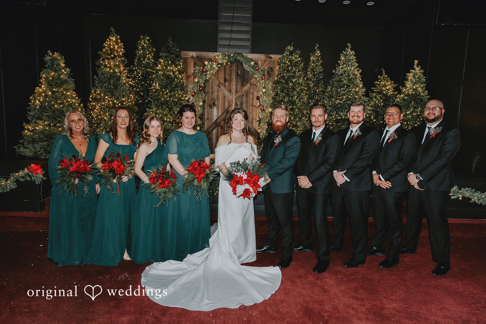 Bride and groom posing with bridesmaids and groomsmen at Bethel Baptist Church captured by Oklahoma City wedding photographers from Original Weddings