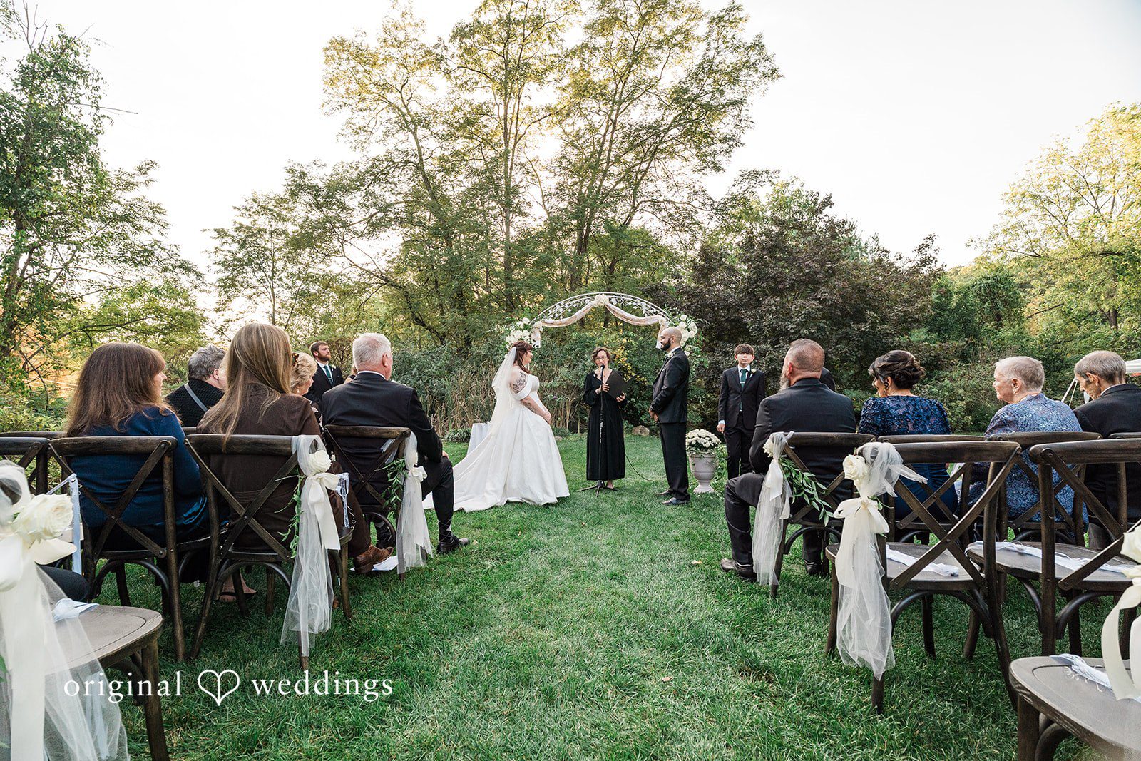 Elegant ceremony scene with couple standing before priest at Bird and Bottle Inn