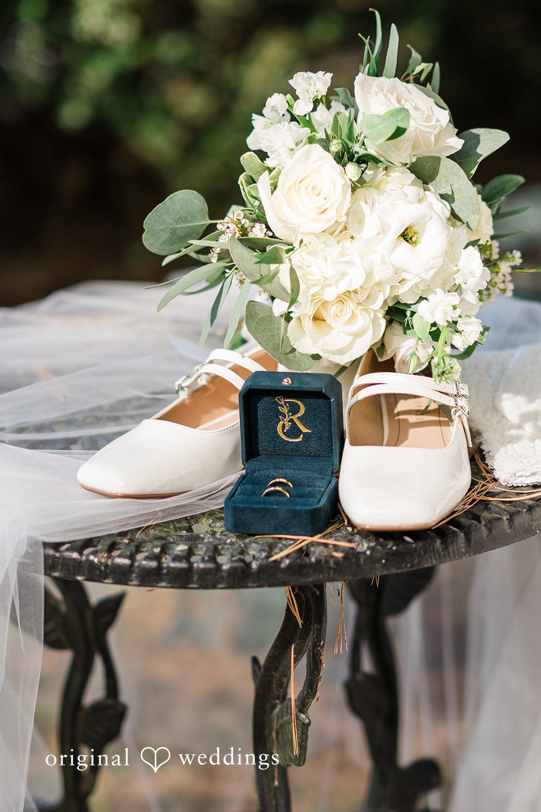 Beautiful wedding detail featuring rings, shoes, and bouquet at Bird and Bottle Inn