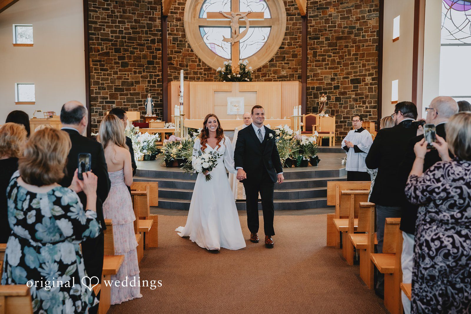 Couple walking down the aisle after the ceremony