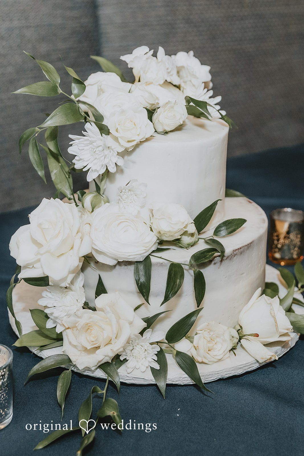 White wedding cake decorated with floral accents