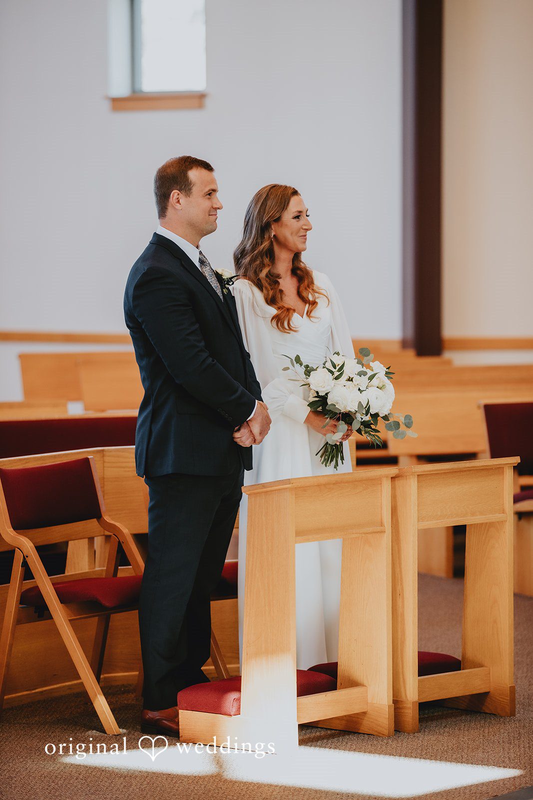 Bride and groom standing together at the altar