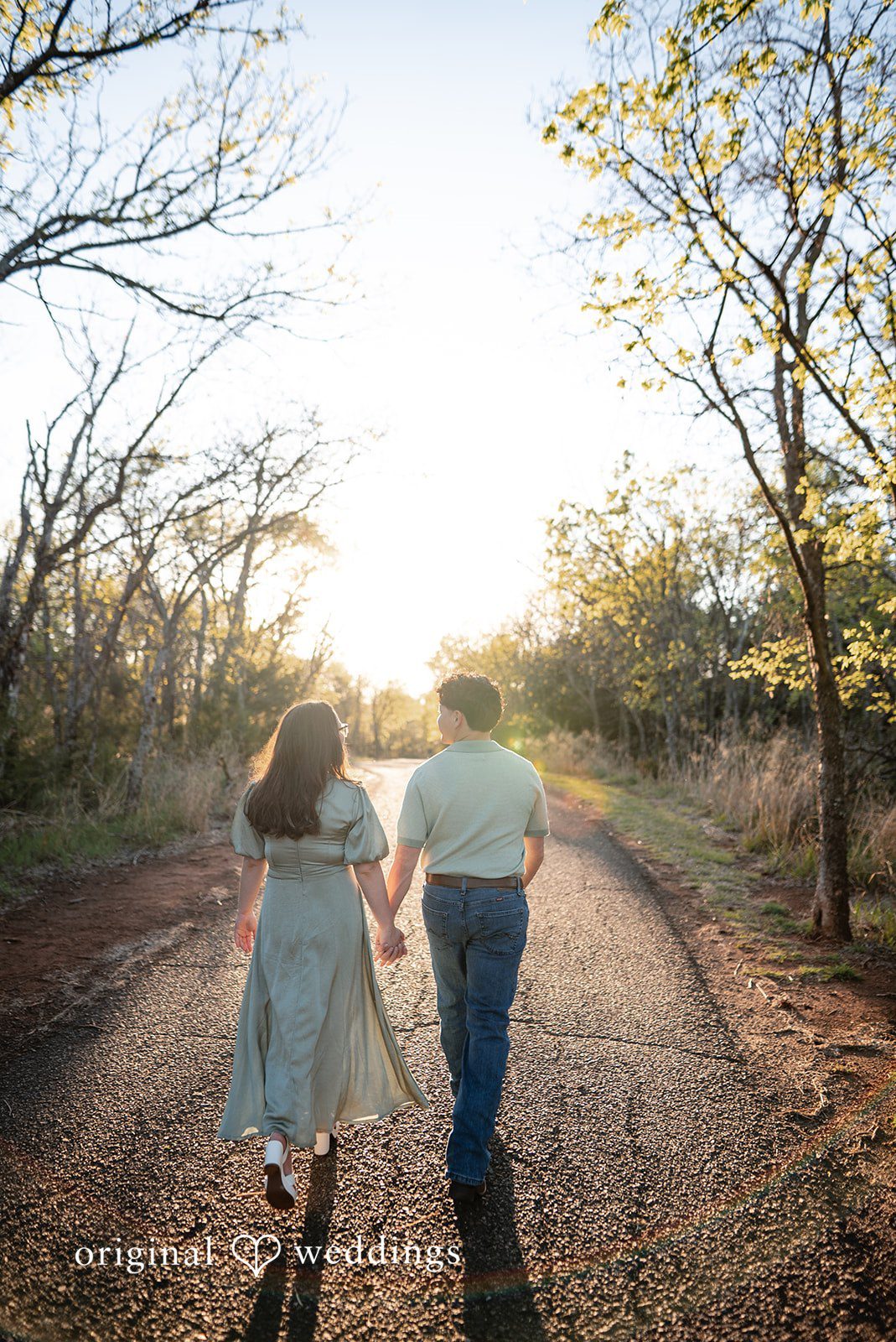 The couple walks through the park
