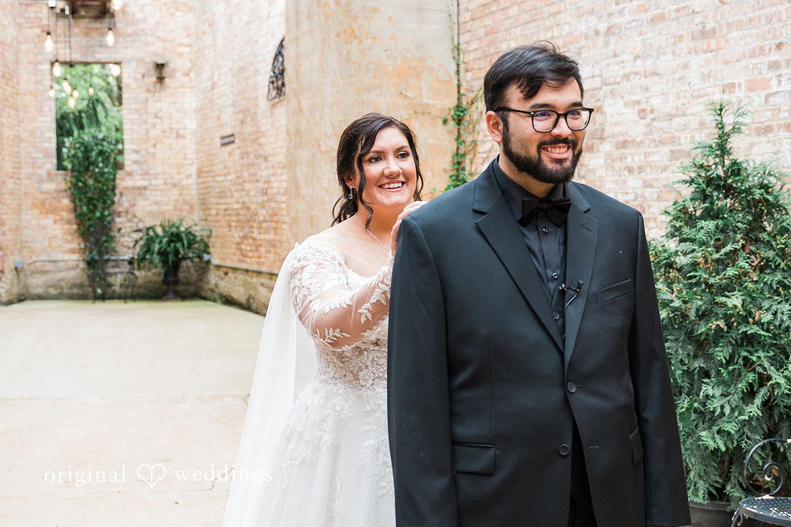 Bride standing behind groom at Blumen Gardens