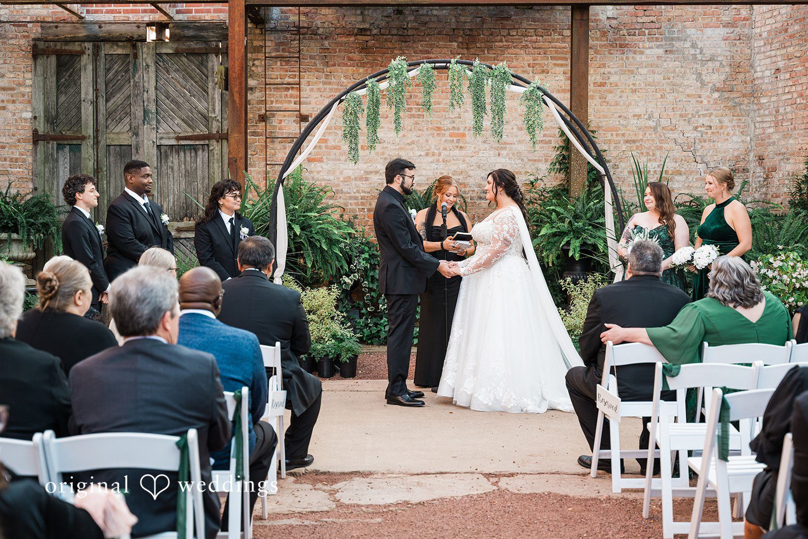 Chicago wedding photographers capturing couple holding hands and looking at each other at Blumen Gardens by Original Weddings