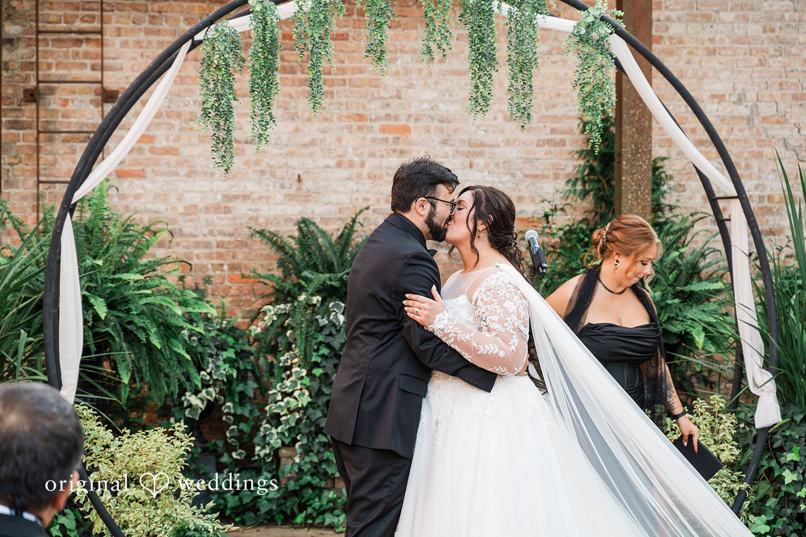 Beautiful couple kissing during wedding moment at Blumen Gardens