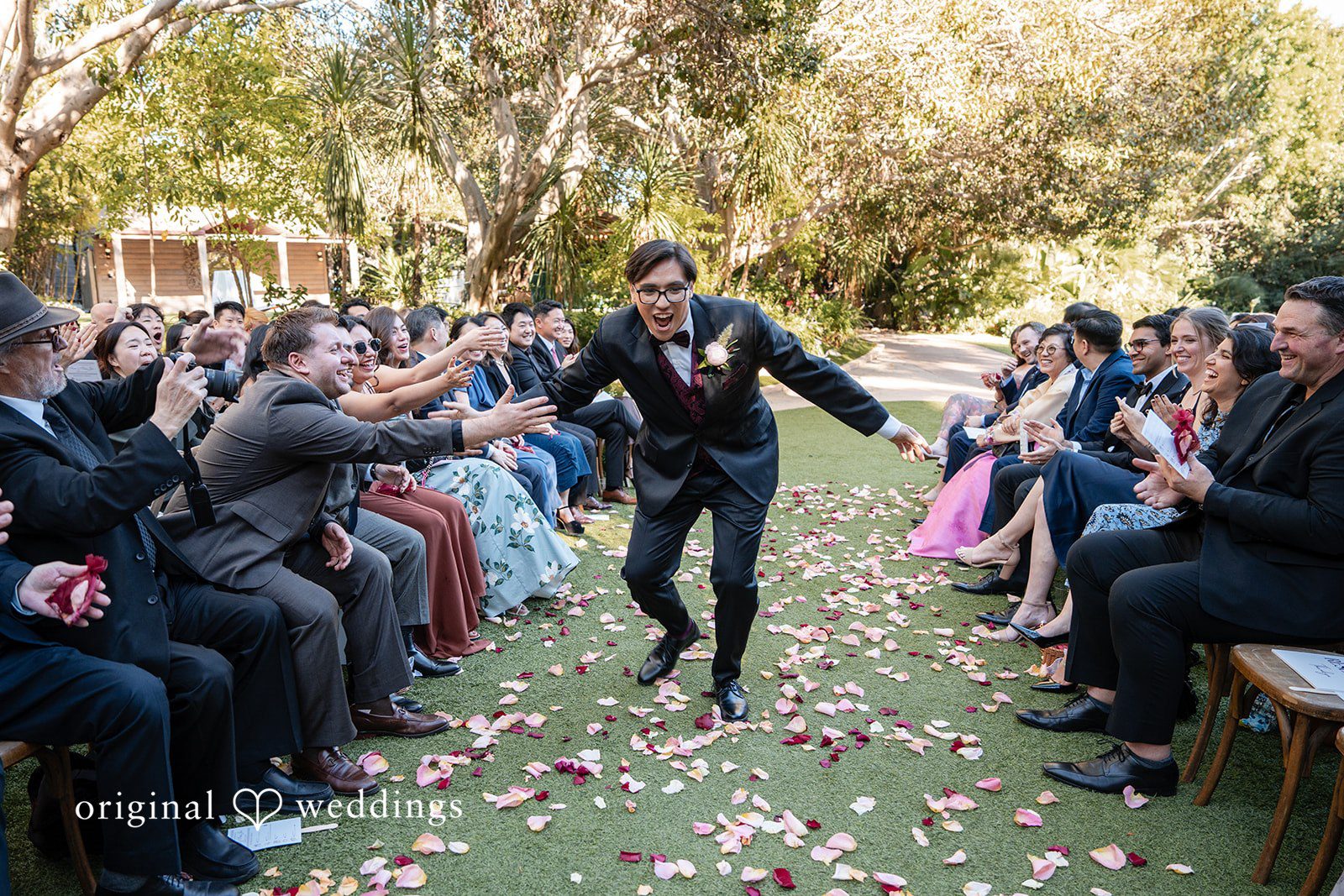 The groom makes a joyful entrance to the wedding ceremony