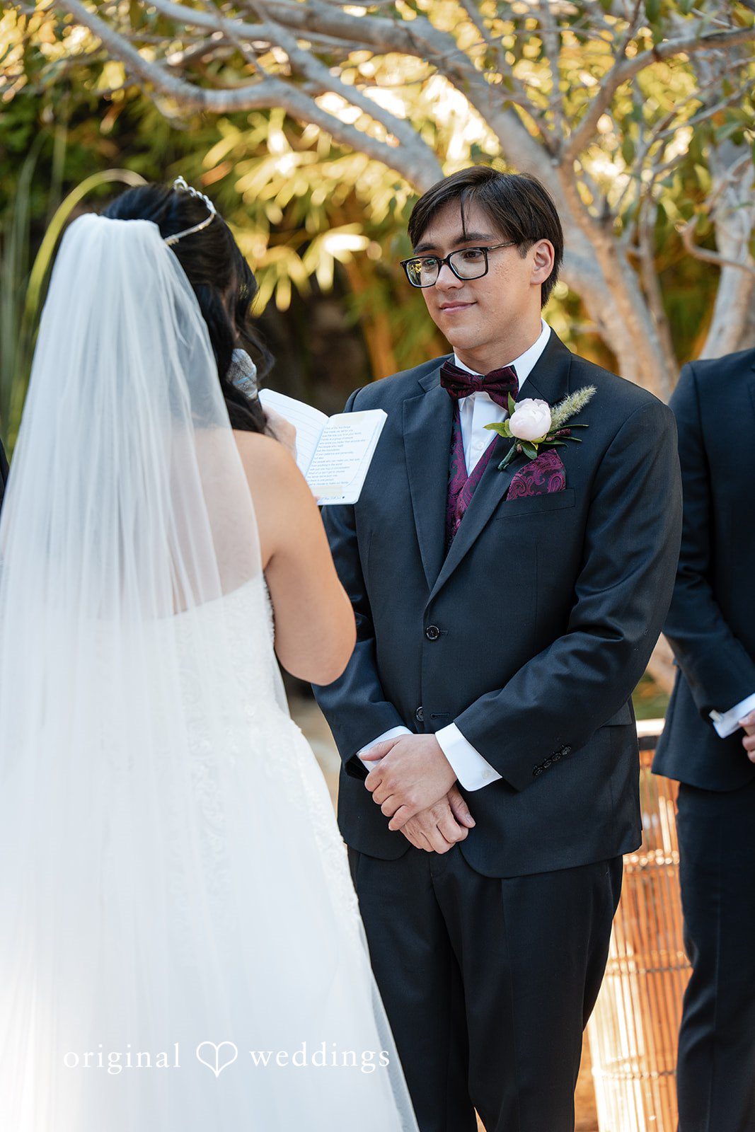The bride reads her vows to the groom