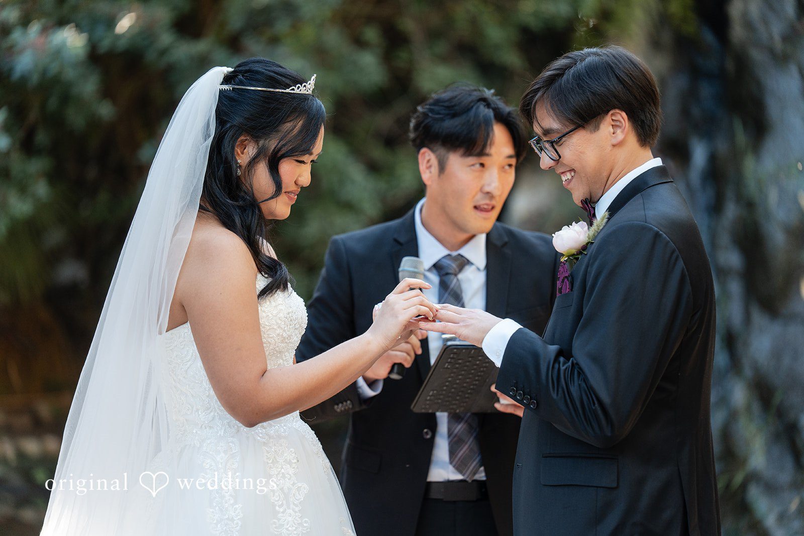 The bride puts a ring on Groom's finger
